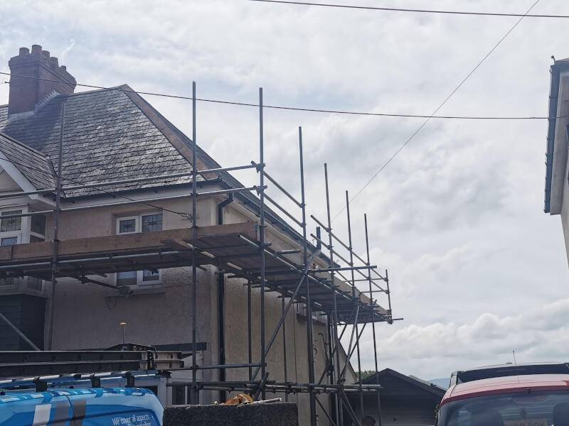 Scaffolding surrounding house roof